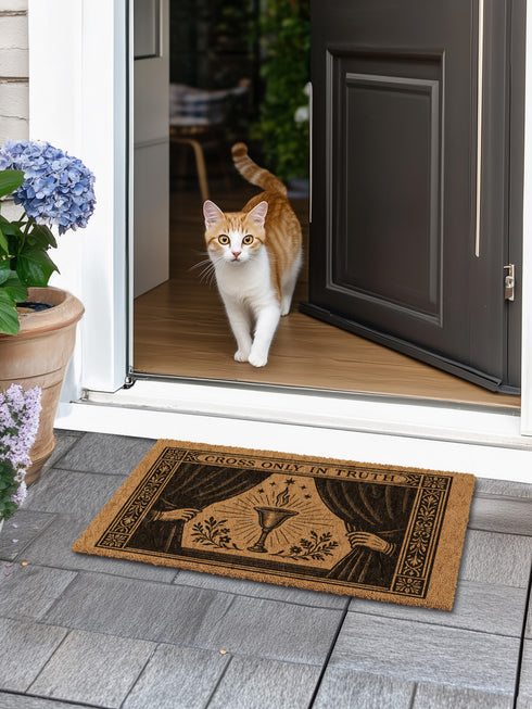 A rectangular doormat made from natural, textured brown coir fiber, featuring a striking black gothic design for spiritual threshold protection. The centerpiece of this witchy welcome mat is a sacred flaming chalice, set between two parted curtains for a dramatic entryway statement. Above the occult imagery, the phrase 'Cross Only In Truth' is printed in a mystical font reminiscent of ancient spellbooks, making this metaphysical and dark academia decor a powerful symbol for a protected home. This is a doorm